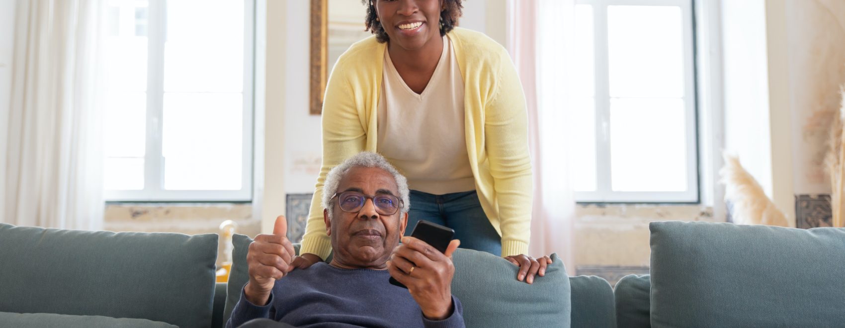 Woman standing behind person on couch courtesy Kampus Production on Pexels