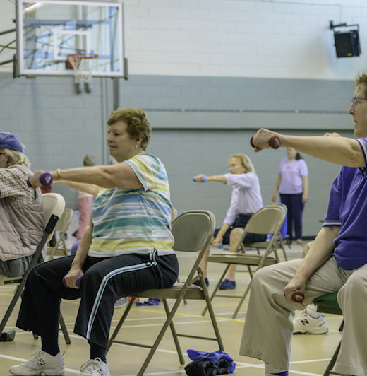 People doing exercise in a gymnasium