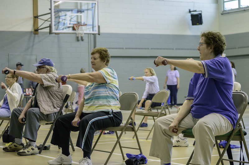 People doing exercise in a gymnasium