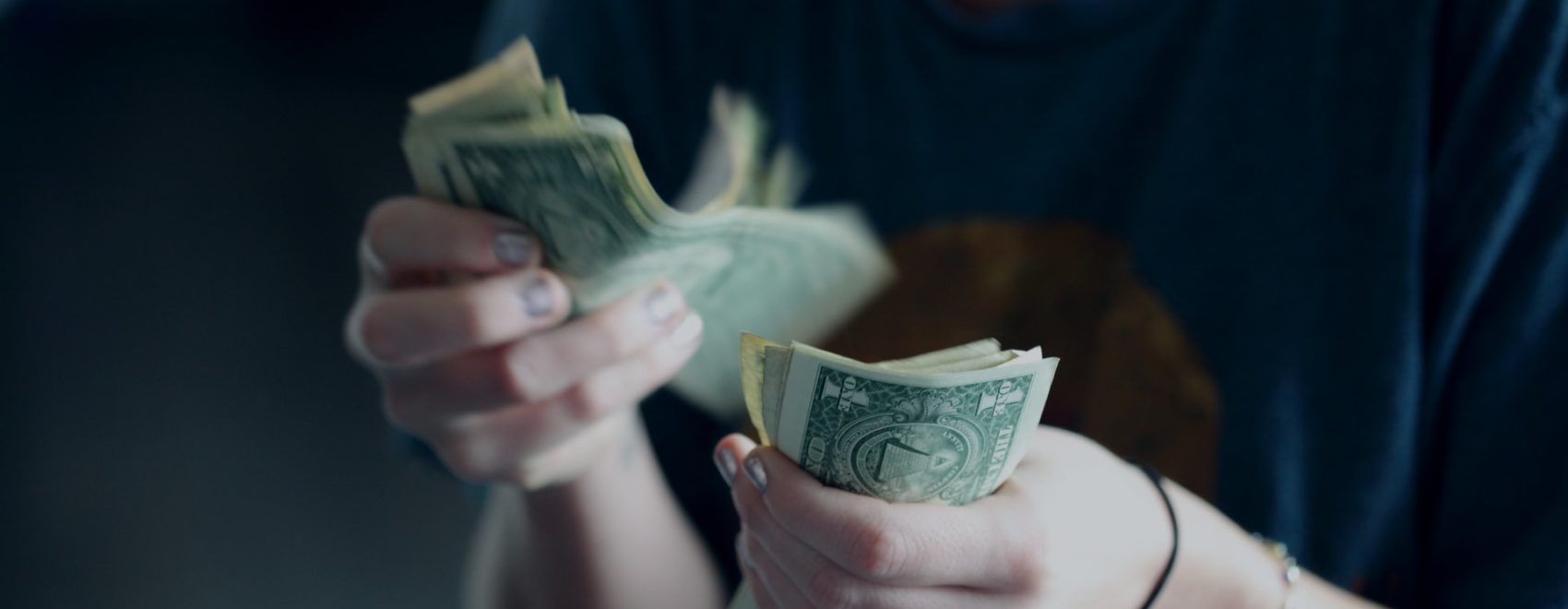 Photo of person counting cash by Sharon McCutcheon on Unsplash