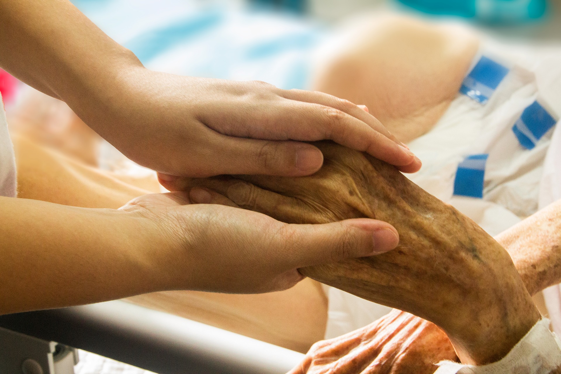 young hands holding an older hand