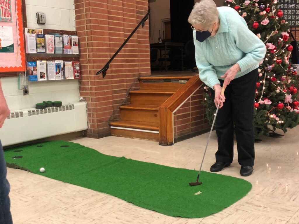Woman practicing on a putting green